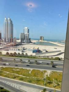 a view of a highway in a city with buildings at Cozy Lovely Apartment in Manama