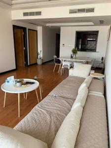 a living room with a couch and a table at Cozy Lovely Apartment in Manama
