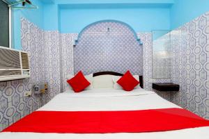 a bedroom with a large bed with red pillows at Hotel Shree Bhumi Puri - 100 Meters From Sea Beach - Best Seller in Puri