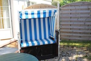 a blue and white beach chair sitting in a yard at Apartment in Westerland in Westerland (Sylt)