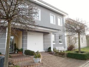a gray house with a bench in front of it at Holiday apartment Schedler in Gerbrunn
