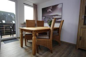 a dining room with a wooden table and chairs at Apartment Tating in Tating