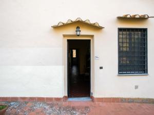 a door leading into a white building at Pleasant Cottage in Asni res with Terrace in Asnières