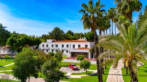 an aerial view of a white house with palm trees at 74 Museum Hotel in Antalya