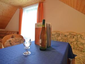 a table with two bottles of wine and a glass at House full of charm with garden 10min from the Pointe du Raz in Cléden-Cap-Sizun
