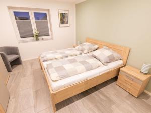 a bedroom with a bed and a window at North Sea holiday home Zinnäcker in Almdorf
