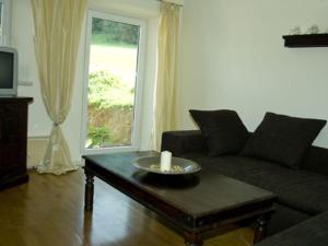 a living room with a couch and a table with a candle at Holiday apartment Diana in Oberstaufen