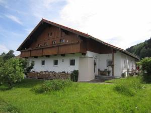 a large white house with a wooden roof at Holiday apartment Diana in Oberstaufen