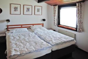 a bed in a bedroom with a window at Tennenbronn Holiday Park Tennenbronn in Tennenbronn