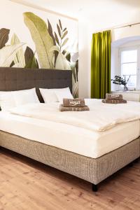 a large bed in a bedroom with a green curtain at Holly GmbH Ferienwohnungen in Bad Alexandersbad