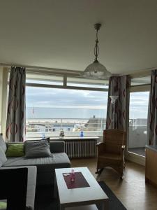 a living room with a view of the ocean at Strandhotel Wohnung 33 in Dahme