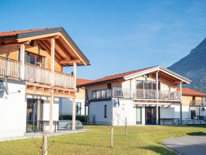 a house with a wrap around porch and balcony at Inzell Chalets with private pool in Inzell