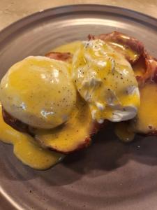 a plate of food with eggs and bacon at OYO The Townhouse in Durham