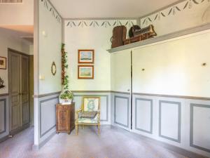 a hallway with a chair and a table in a room at Cozy Apartment with Swimming Pool Terrace Garden Parking in Montbrun-les-Bains