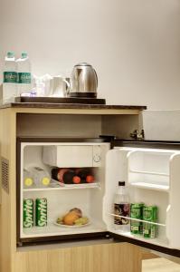 an open refrigerator with food inside of it at Hotel Star Villa - Front of New Delhi Railway Station in New Delhi