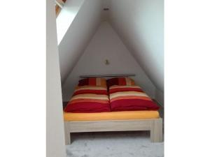 a bed in the middle of a attic at Holiday apartment Grohnert in Lübeck