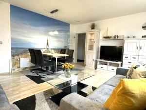 a living room with a couch and a table at Nice apartment near beach in Cuxhaven