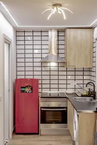 cocina con nevera roja y fregadero en Apartamentos Estrecho, en Madrid
