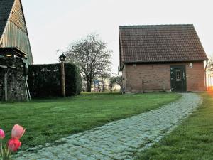 a brick building with a brick path next to a house at Lovely Holiday Home in Zierow with Terrace in Zierow