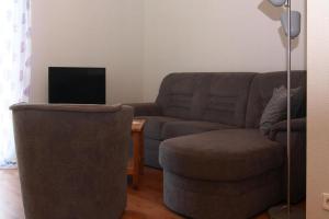 a living room with a couch and a chair at Holiday home lake view Zemitz in Zemitz