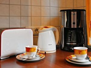 a counter with two coffee cups and a toaster at Appealing apartment in Motten in Motten