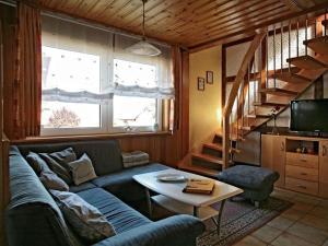 a living room with a couch and a table at Appealing apartment in Motten in Motten