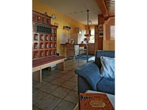 a living room with a blue couch and a kitchen at Appealing apartment in Motten in Motten +14 photos