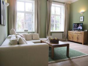 a living room with a white couch and a table at Apartment in Garz with bicycle storage in Garz-Rügen