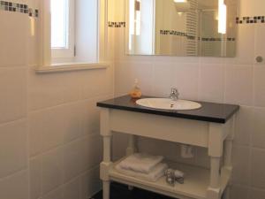 a bathroom with a sink and a mirror at Apartment in Garz with bicycle storage in Garz-Rügen