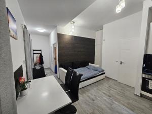 a living room with a bed and a table at Spílerapartman 1 in Balatonalmádi