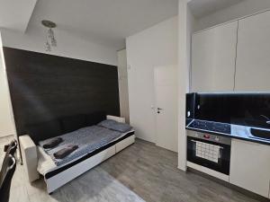 a bedroom with a bed and a flat screen tv at Spílerapartman 1 in Balatonalmádi