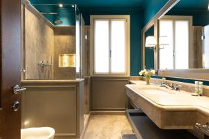 a bathroom with a sink and a mirror at Dimora San Trovaso Enchanting Four-bedrooms in Venice
