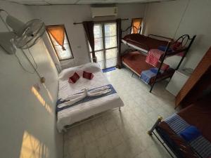 an overhead view of a bedroom with a bed and a bunk bed at Noot's Bar And Guesthouse in Kanchanaburi