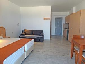 a bedroom with a bed and a couch in a room at Marel Apartments in Rethymno