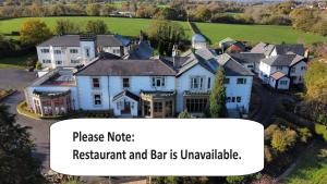 a house with a sign that reads please note restaurant and bar is unavailable at Northop Hall Country House Hotel in Mold