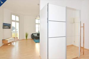 a large white refrigerator in a living room at Apartment Karlskrona in Ahlbeck