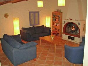 a living room with two couches and a fireplace at Tranquil holiday home in Carc s with private pool in Carcès