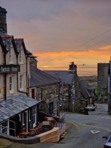 a view of a town at sunset at Harlech House in Harlech