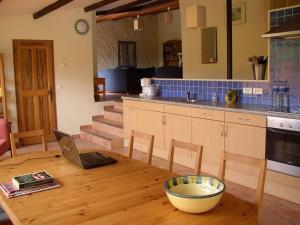 a kitchen with a wooden table with a laptop on it at Tranquil holiday home in Carc s with private pool in Carcès