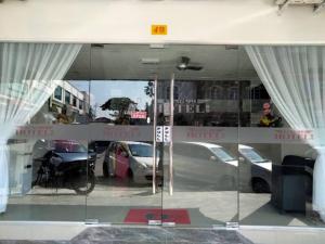 a reflection of cars in the window of a store at OYO 90953 Song 99 Hotel in Kluang
