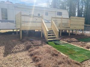 an rv with a deck and a trailer at Romantic getaway in Decatur