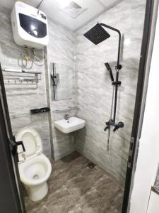 a small bathroom with a toilet and a sink at Era Apartment Ham Long in Hanoi