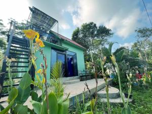 a house with a blue and green facade at Plankton Bungalow and Camping in Koh Rong Island