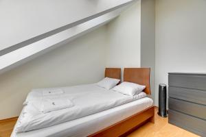 a bedroom with a bed and a dresser at Dom & House - Apartment Chopina 37 Supreme in Sopot