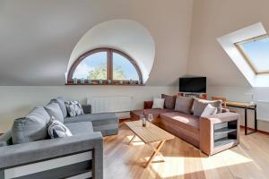 a living room with two couches and a window at Dom & House - Apartment Chopina 37 Supreme in Sopot
