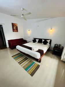 a bedroom with a large bed and a rug at Red Stone Villas in Madikeri