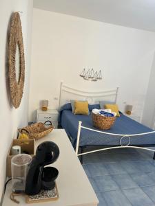 a bedroom with a bed and a table with a table at Casa San Domingo in Marina di Camerota