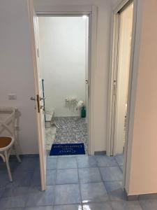 an open door to a room with a tile floor at Casa San Domingo in Marina di Camerota