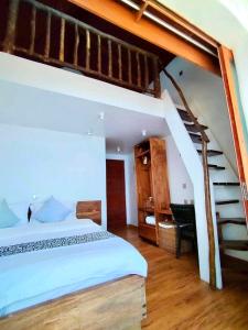 a bedroom with a bunk bed and a staircase at Dive and Trek Resort and Marine Sanctuary in Bauan