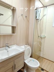 a bathroom with a shower and a toilet and a sink at Vivi Homestay in Nilai +12 photos